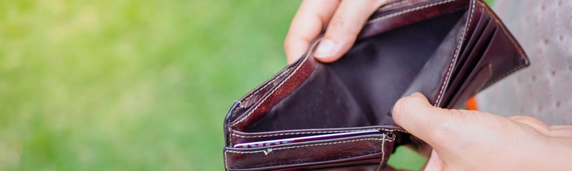 Unhappy bankrupt woman with empty wallet. Young woman shows her empty wallet. Bankruptcy