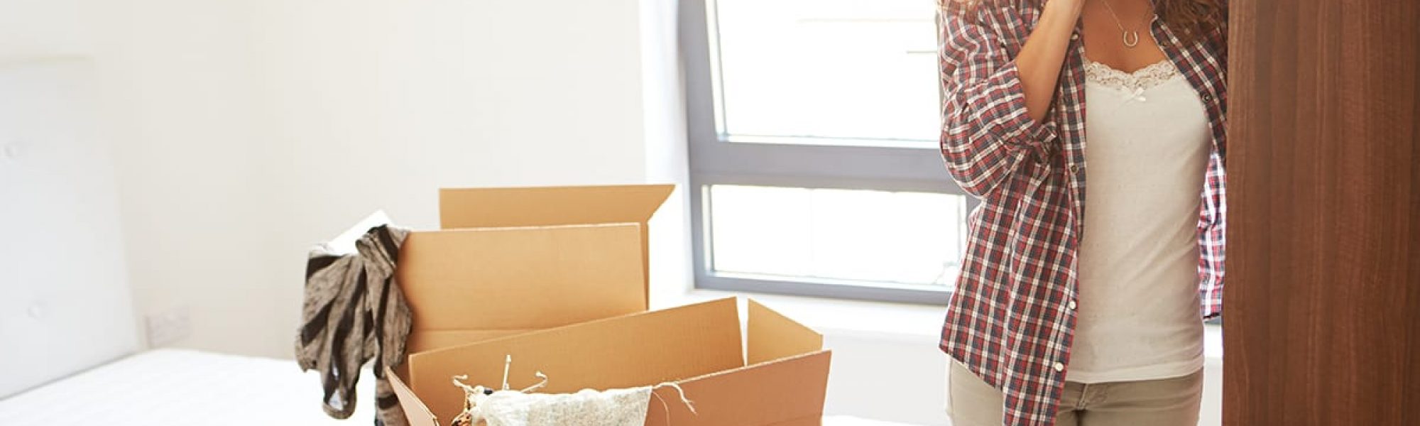 Woman Moving Into New Home Talking On Mobile Phone Woman Moving Into New Home Talking On Mobile Phone