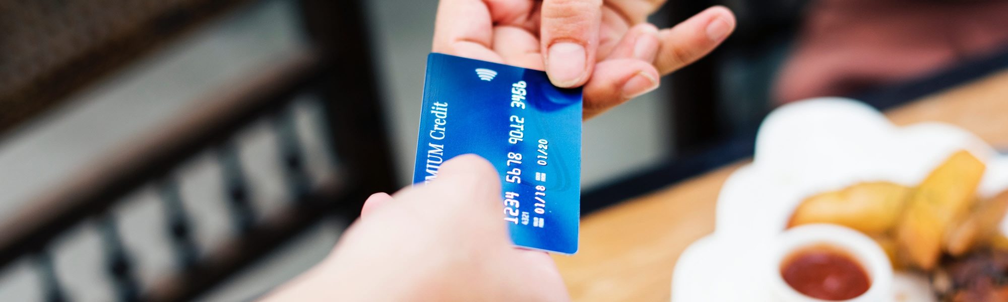banking-card-credit-card-1332191 guy purchasing something at a restaurant with a credit card
